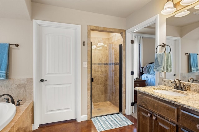 full bathroom featuring a garden tub, a shower stall, and vanity