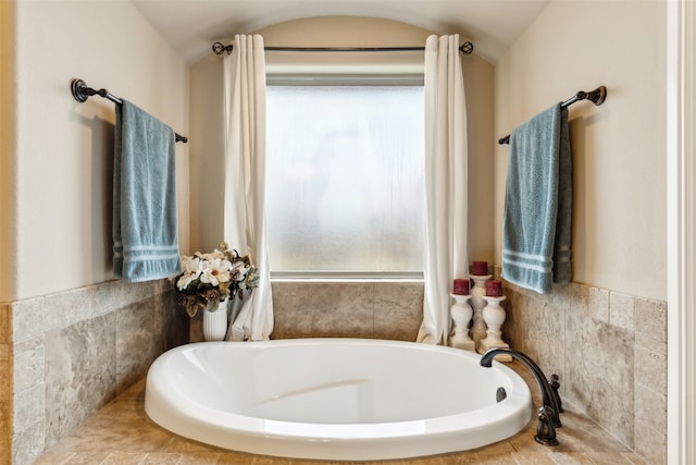 bathroom featuring tiled bath