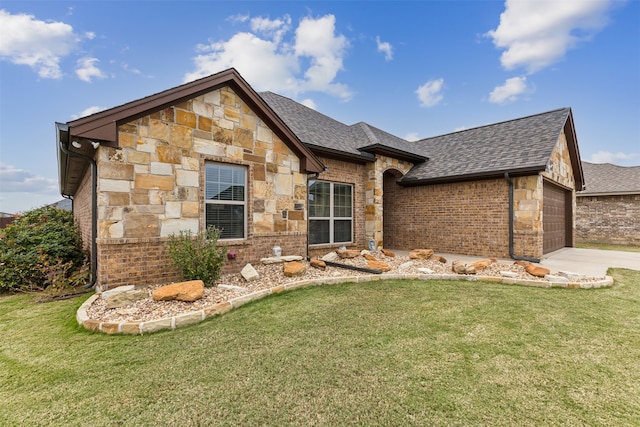 view of front of home with a garage and a front lawn