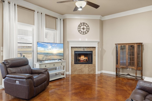 living room with a fireplace, ornamental molding, ceiling fan, concrete floors, and baseboards