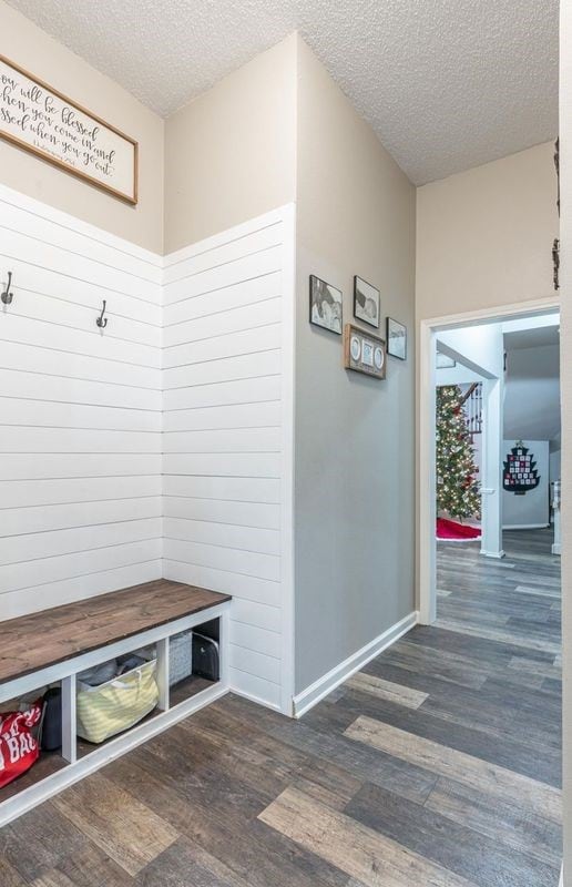 mudroom with dark hardwood / wood-style floors and a textured ceiling