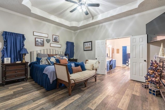 bedroom featuring crown molding, a textured ceiling, dark hardwood / wood-style floors, a raised ceiling, and ceiling fan