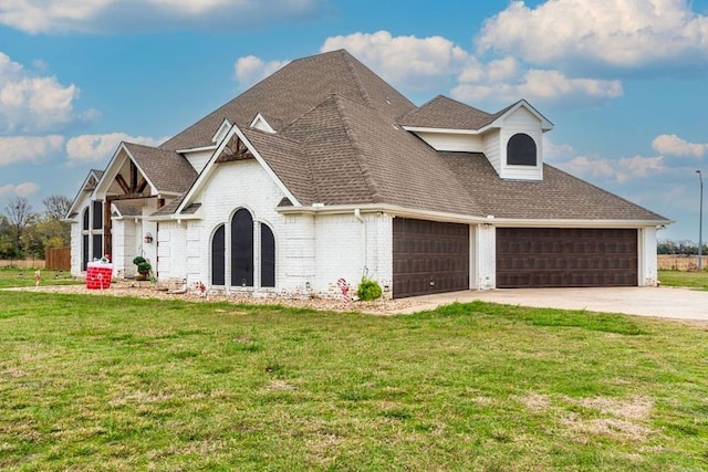 view of front facade with a front yard and a garage