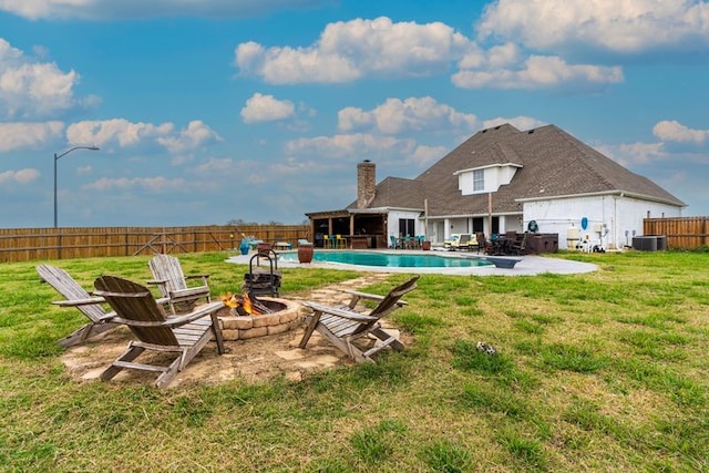 exterior space featuring a fenced in pool, central AC unit, a patio, and an outdoor fire pit