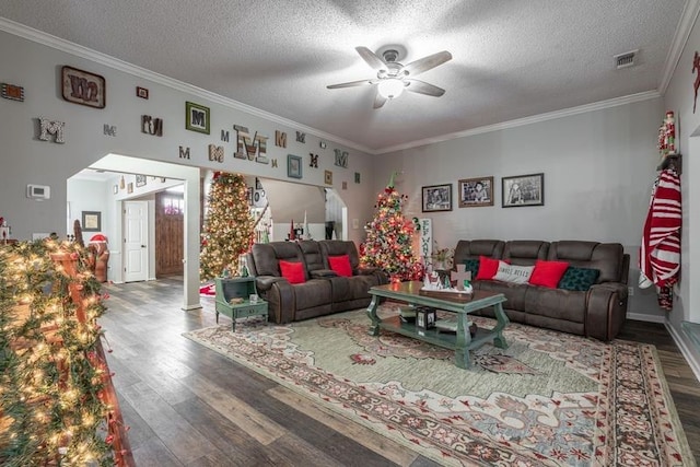 living room featuring crown molding, ceiling fan, a textured ceiling, and hardwood / wood-style flooring