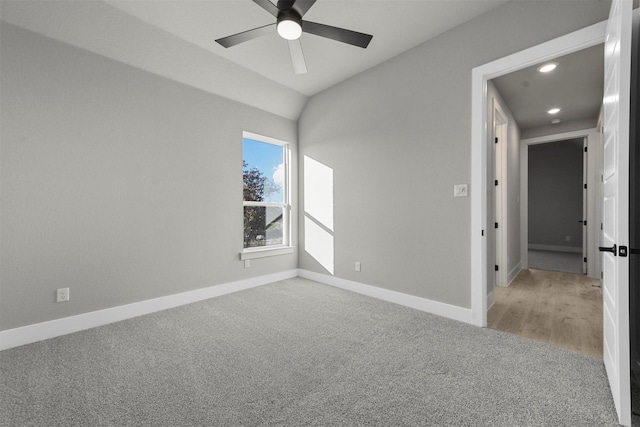 unfurnished room with carpet flooring, ceiling fan, and vaulted ceiling