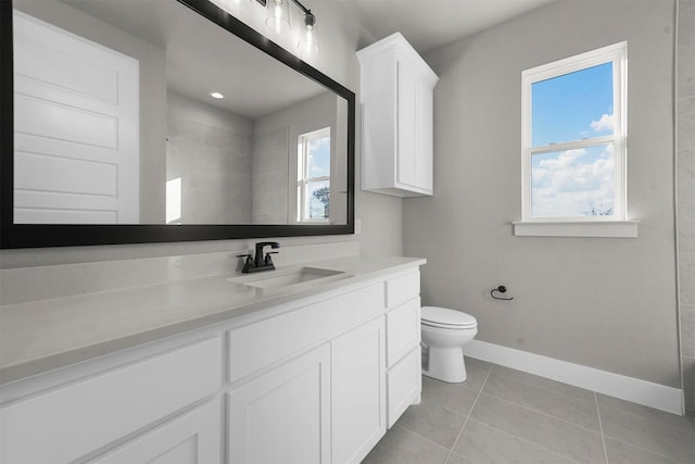 bathroom with tile patterned flooring, vanity, toilet, and walk in shower