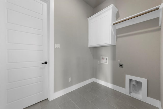 clothes washing area featuring hookup for an electric dryer, cabinets, tile patterned floors, and washer hookup