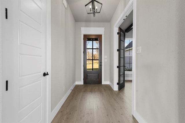 entryway featuring a chandelier and light wood-type flooring