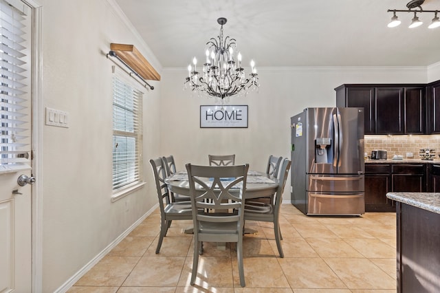 tiled dining room with a notable chandelier and crown molding