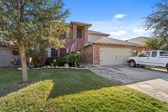 view of front of home with central air condition unit, a front yard, and a garage