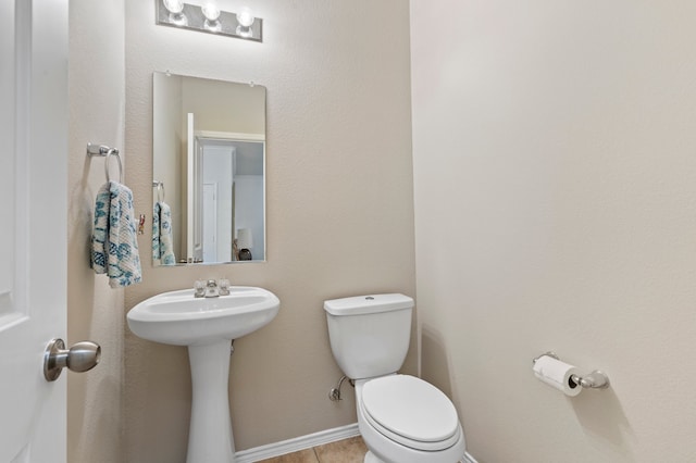 bathroom with tile patterned flooring and toilet