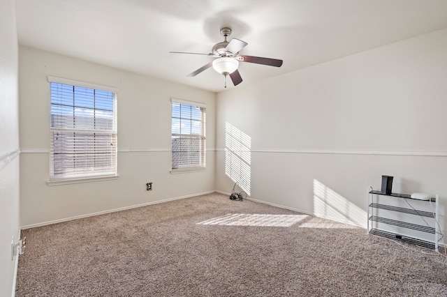 spare room featuring carpet flooring and ceiling fan