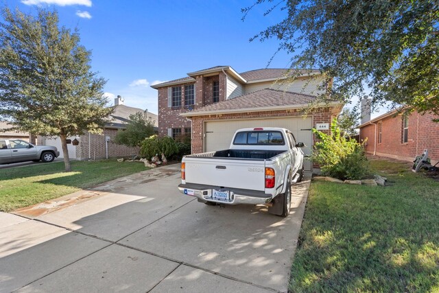 view of front of house with a garage and a front lawn