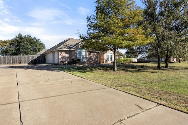 view of front facade featuring a garage and a front lawn