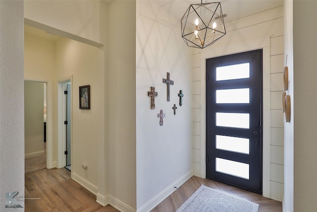 foyer featuring a notable chandelier and wood-type flooring