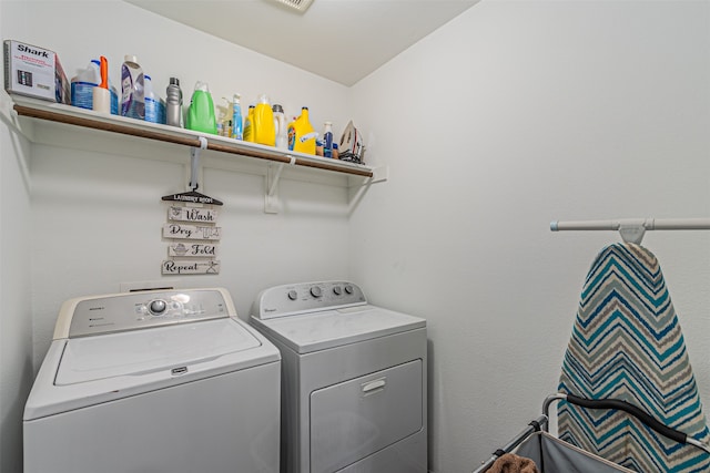 washroom with washing machine and clothes dryer