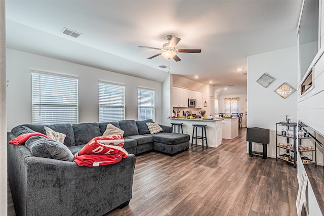 living room with ceiling fan, dark hardwood / wood-style flooring, and lofted ceiling