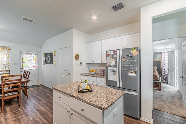 kitchen featuring light stone counters, dark hardwood / wood-style flooring, white cabinets, and stainless steel refrigerator with ice dispenser