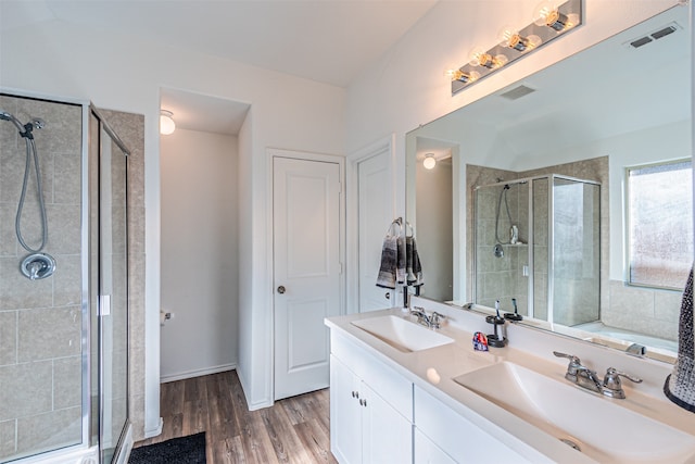 bathroom with lofted ceiling, vanity, wood-type flooring, and an enclosed shower