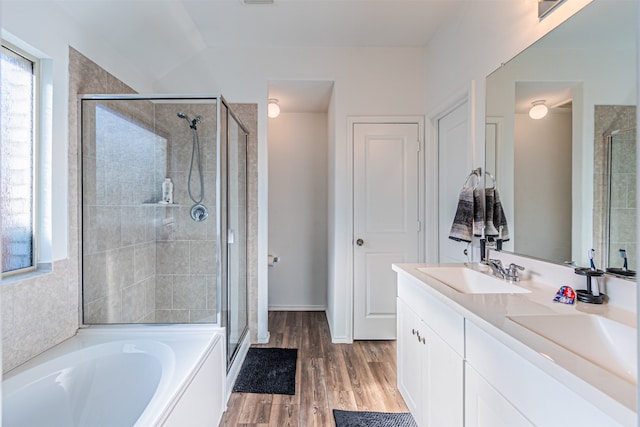 bathroom featuring hardwood / wood-style floors, vanity, and separate shower and tub