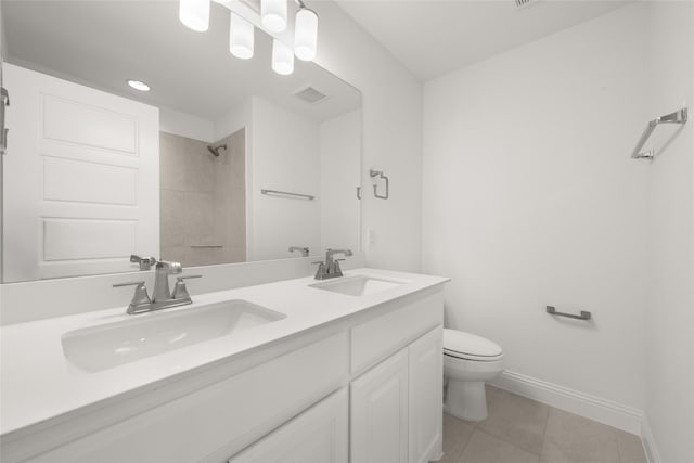 1536 Euclid Aly, Corinth, TX 76208 - bathroom with baseboards, toilet, tile patterned flooring, a shower, and double vanity