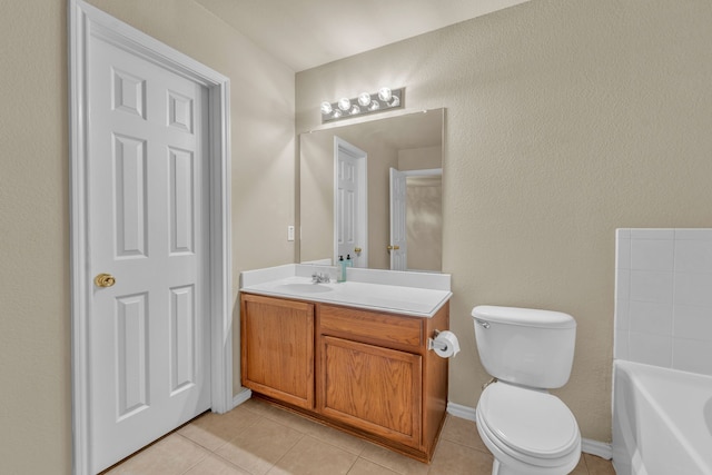 bathroom featuring a tub, tile patterned flooring, vanity, and toilet