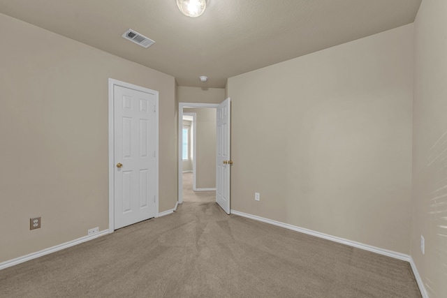 empty room with light colored carpet