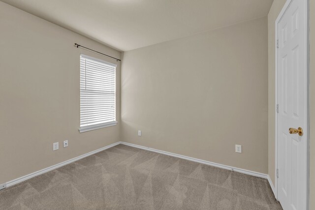 spare room featuring light colored carpet