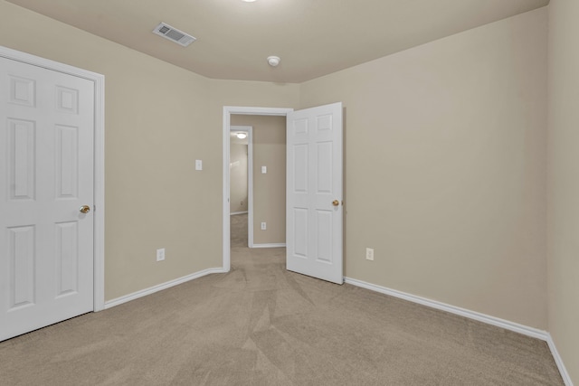 unfurnished bedroom featuring light colored carpet