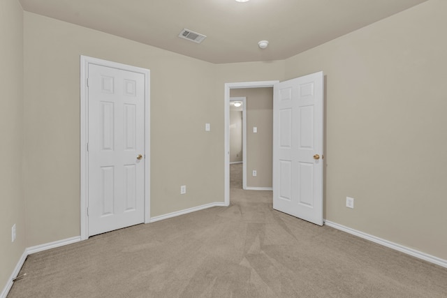 unfurnished bedroom with light carpet