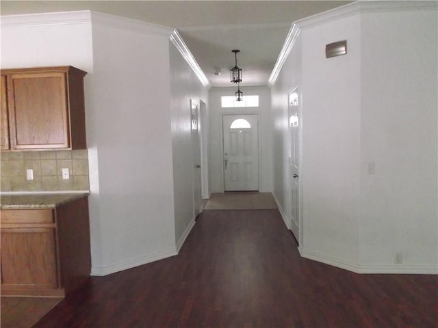 foyer with dark hardwood / wood-style flooring and crown molding