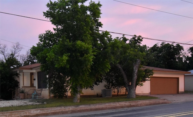 obstructed view of property with a garage