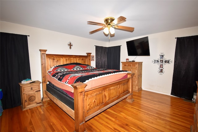 bedroom with wood-type flooring and ceiling fan