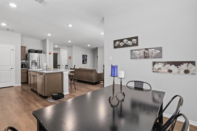 dining area featuring wood-type flooring and sink