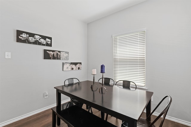 dining space with dark wood-type flooring