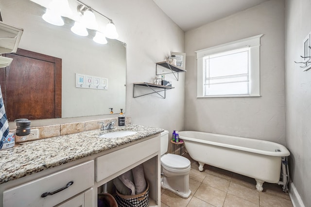 full bathroom with toilet, a soaking tub, tile patterned floors, and vanity