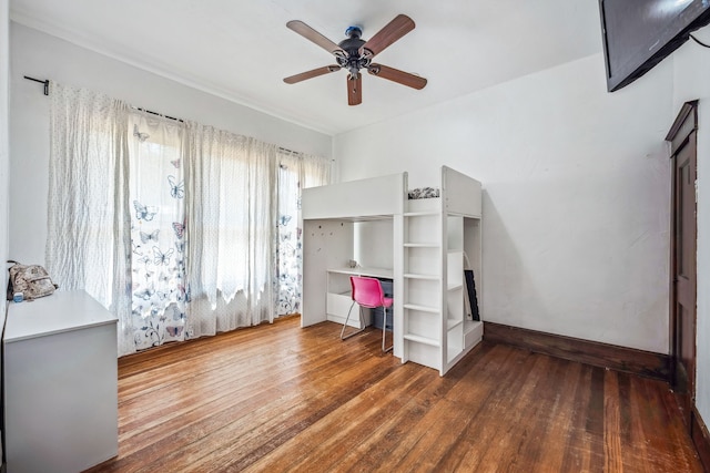 unfurnished bedroom with dark wood-style flooring and ceiling fan