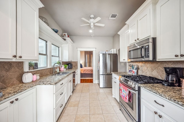 kitchen with white cabinetry, appliances with stainless steel finishes, and a sink