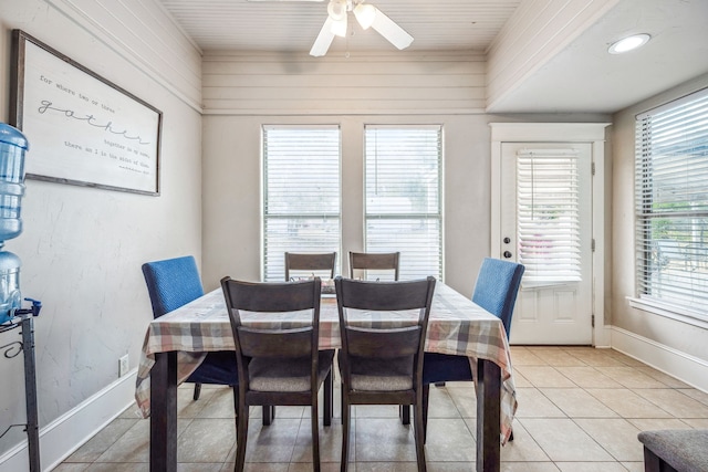 dining area with light tile patterned flooring, ceiling fan, and baseboards