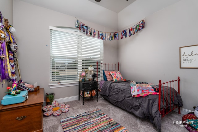 bedroom featuring light carpet and multiple windows