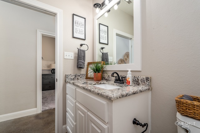 bathroom featuring vanity and toilet