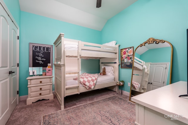 carpeted bedroom featuring ceiling fan, a closet, and vaulted ceiling