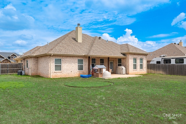 rear view of house with a yard, a patio, and cooling unit