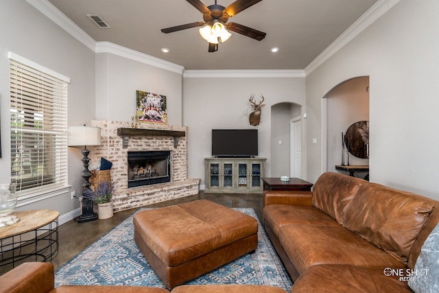 living room featuring ceiling fan, ornamental molding, and a brick fireplace