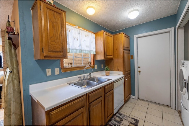 kitchen with dishwasher, light tile patterned floors, a textured ceiling, and sink