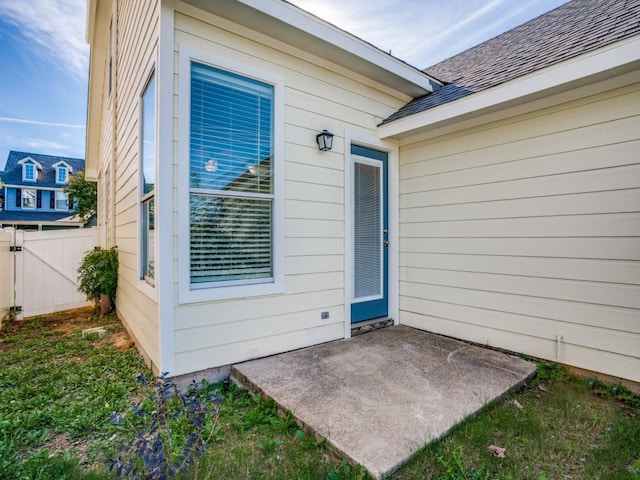 view of exterior entry with a patio area