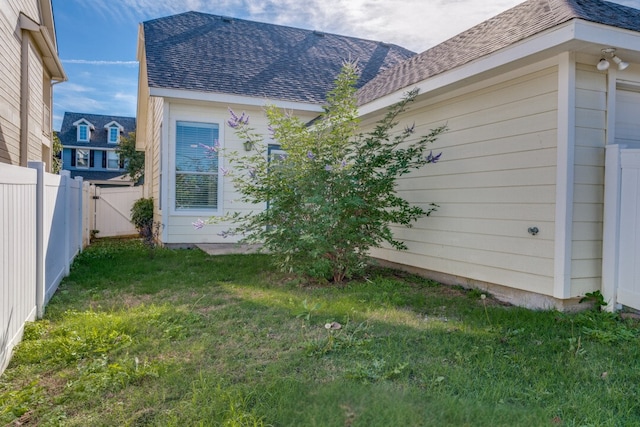 view of side of home with a lawn