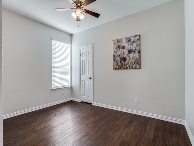 unfurnished room featuring ceiling fan and dark wood-type flooring