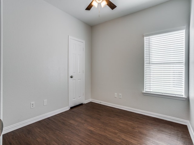 empty room featuring ceiling fan and dark hardwood / wood-style flooring